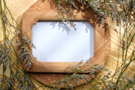 mockup wooden photo frame on round table with evening sunlightの写真素材