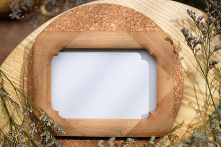 mockup wooden photo frame on round table with evening sunlightの写真素材