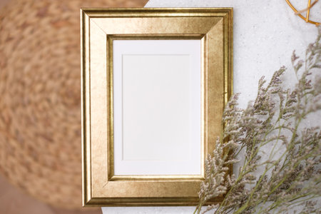 mockup gold photo frame on white stone round table with sunlightの写真素材