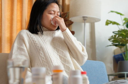 asian woman get flu and cough sick at homeの写真素材
