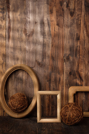 mockup group of wood photo frames on wood table and decor with wicker decoration itemsの写真素材