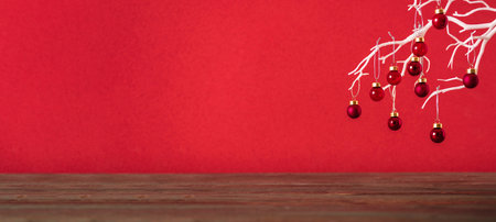 Merry christmas with xmas tree and bauble ball at vivid red wall at wooden table.copy space for...