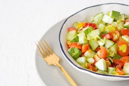 mediterranean salad in white bowl healthy food on tableの写真素材