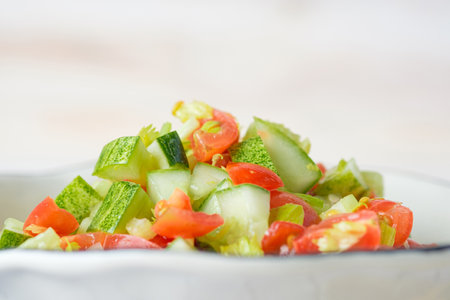 mediterranean salad in white bowl healthy food on tableの写真素材