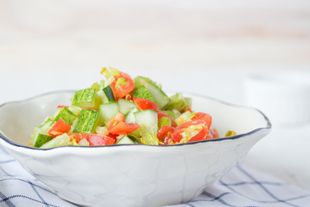mediterranean salad in white bowl healthy food on tableの写真素材