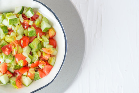 mediterranean salad in white bowl healthy food on tableの写真素材