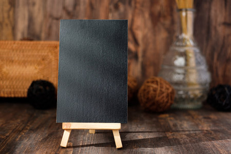 mockup blackbaord on wood table and decor with wicker countryside items.の写真素材
