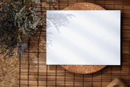 Mockup paper poster card on brown mat with sunlightの写真素材