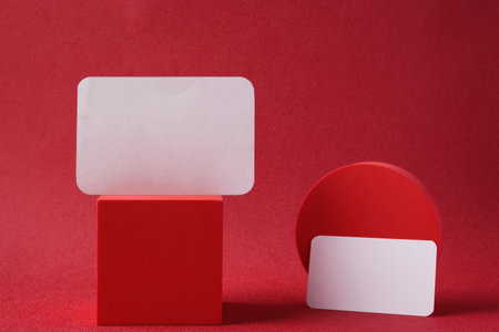 mockup business card paper with pedestal on red backgroundの写真素材