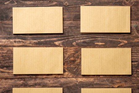 top view of group of yellow notepad align on wood tableの写真素材