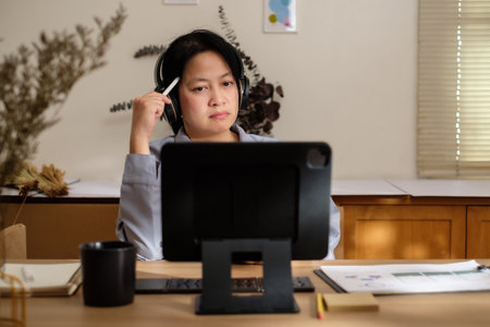 asian woman planning business goal using tablet at homeの写真素材