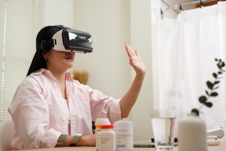 asian woman telemedicine doctor online visit with virtual reality technology vr glasses at homeの写真素材