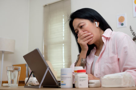 asian woman telemedicine doctor online visit with computer at homeの写真素材