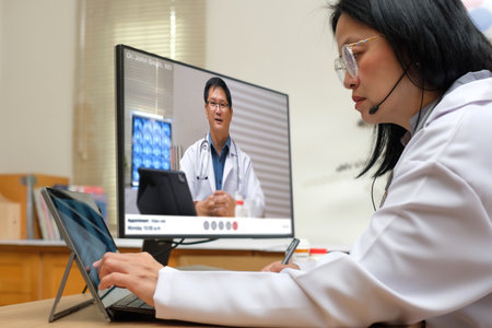 Asian woman doctor video conference discussion with doctor team about diagnosis patient symptomの写真素材