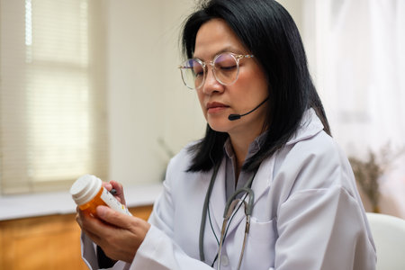 asian woman doctor visit patient video call online diagnose symptom at clinicの写真素材