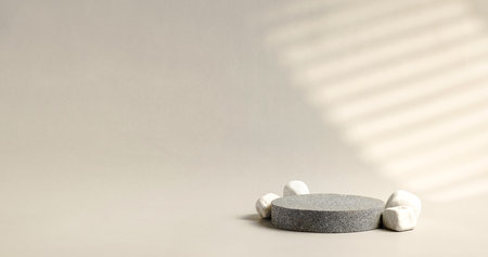 Minimal stone stage product display with sunlight from window on cream color backgroundの写真素材