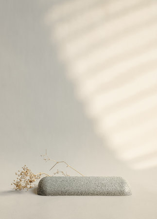 Minimal round stone and dry flower product display with sunlight from window on cream color backgroundの写真素材