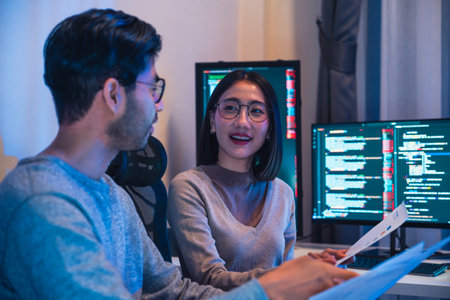 asian and Indian Developer  devops team discussion  about coding promgram with software computer at night in officeの写真素材