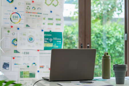 ESG ( environment, social,governance) recycle sign on laptop screen with carbon free chart board in officeの写真素材
