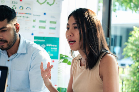 diversity team brainstorming discussion focused on ESG (environment,social,governance)  for sdgs goals in a sustainable green officeの写真素材
