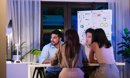 diversity team discusstion about esg and eco friendly system planning in sustainable green office at nightの写真素材