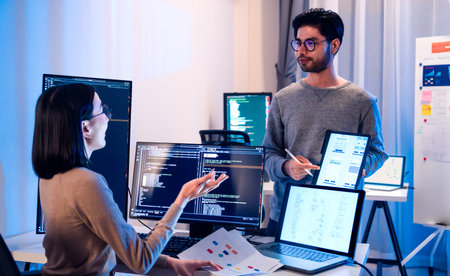 asian and Indian Developer team discussion feedback analysis coding data with software computer at...