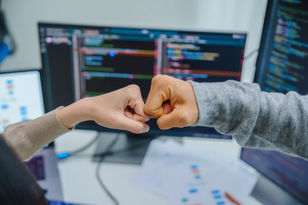asian and Indian Developer team clapping hand for project success  with software computer at officeの写真素材