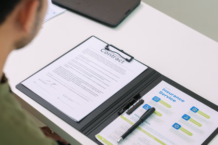 Asian couple reviewing and sign contract financial documents with the guidance of  advisor at...