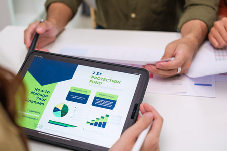 asian financial advisor presenting charts and data on a tablet during couple client...