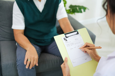 Doctor Writing Prescription for Elderly Patient During Clinic or Hospital Visitの写真素材