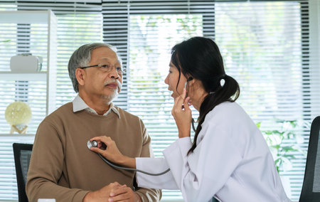 Doctor Using Stethoscope to Check Senior Patient's cardiology and respiratory in Hospitalの写真素材