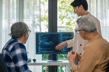 senior programmer bootcamp, young instructor guides senior learners through programming on whiteboard, highlighting algorithm thinking and simple code exercisesの写真素材