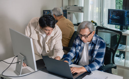 Group of asian senior in a collaborative software development analyzing  flowcharts  during a bootcamp trainingの写真素材