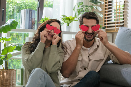 Cheerful hispanic couple having fun together on Valentineâs Day, showing love, heart, and romantic relationship with happy emotionsの写真素材