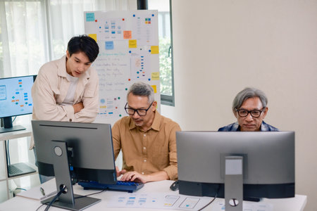 Asian Instructor Teaching Senior in Software Programming and Training Collaborationの写真素材