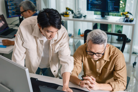 Group of asian senior in a collaborative software development analyzing  flowcharts  during a bootcamp trainingの写真素材