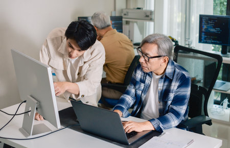 Group of asian senior in a collaborative software development analyzing  flowcharts  during a bootcamp trainingの写真素材