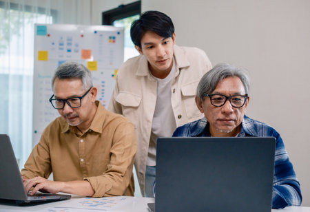 Asian Instructor Teaching Senior in Software Programming and Training Collaborationの写真素材