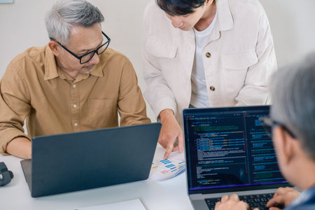 Group of asian senior in a collaborative software development analyzing  flowcharts  during a bootcamp trainingの写真素材