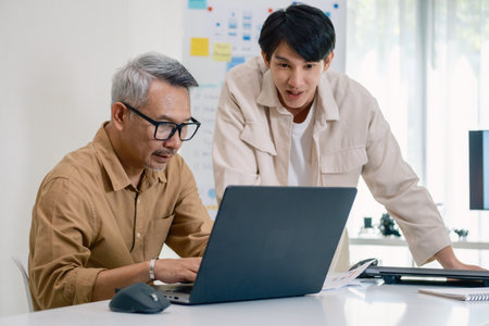 Asian Instructor Teaching Senior in Software Programming and Training Collaborationの写真素材