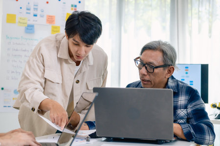 Group of asian senior in a collaborative software development analyzing  flowcharts  during a bootcamp trainingの写真素材