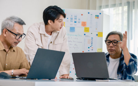 Asian senior bootcamp team asking and  learning programming with software training and whiteboard collaborationの写真素材