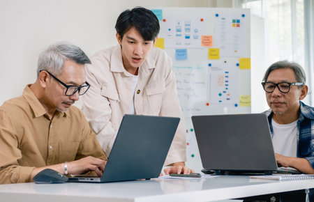 Asian Instructor Teaching Senior in Software Programming and Training Collaborationの写真素材