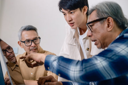 Asian Instructor Teaching Senior in Software Programming and Training Collaboration
