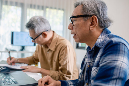 Senior male participating in a computer programming bootcamp, improving skills and learning coding and develope collaborating in brainstorming and coding projectの写真素材