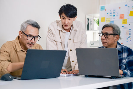 Asian Instructor Teaching Senior in Software Programming and Training Collaboration