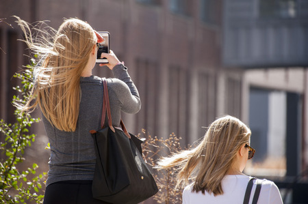 Tourist photographing from the High Line Park, New York Cityの写真素材
