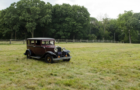 Classic vintage car in open grassy field