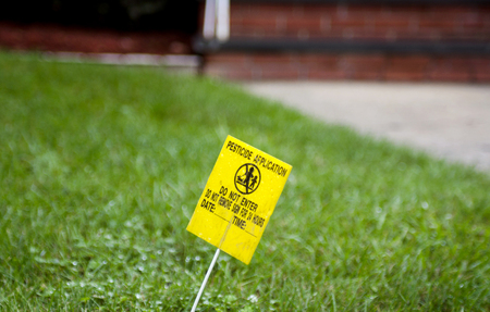 Yellow Pesticide Application Warning Sign On Green Grassの写真素材