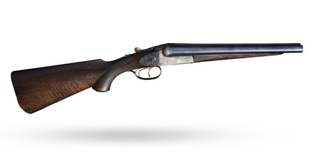 Old jeans on white background. Isolated short gun with wooden butt. Lovely historical isolated...